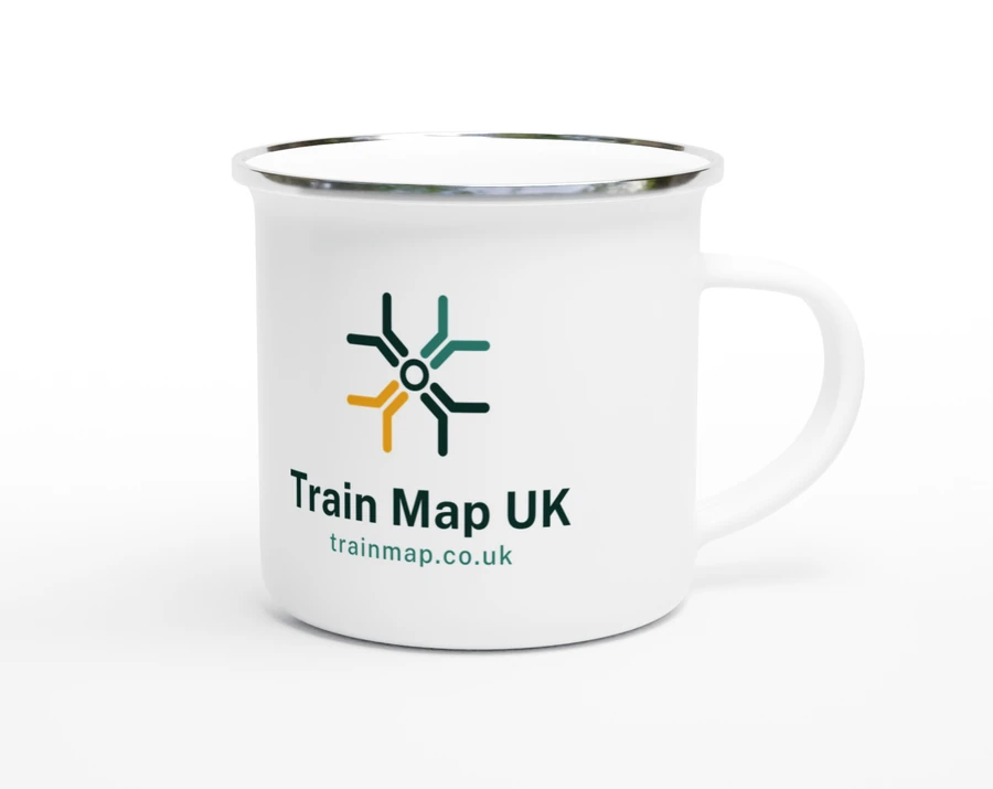 A 12 oz white enamel mug with a silver rim, handle to the right, carrying the Train Map UK junction mark above the name and the address